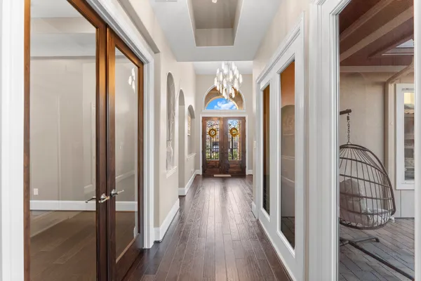 a view of a hallway with wooden floor and staircase
