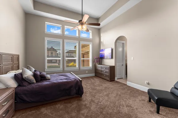 a spacious bedroom with a bed window and a table