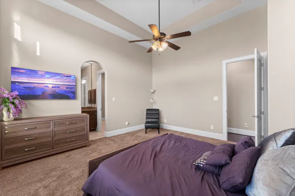 a bedroom with a bed and a chandelier