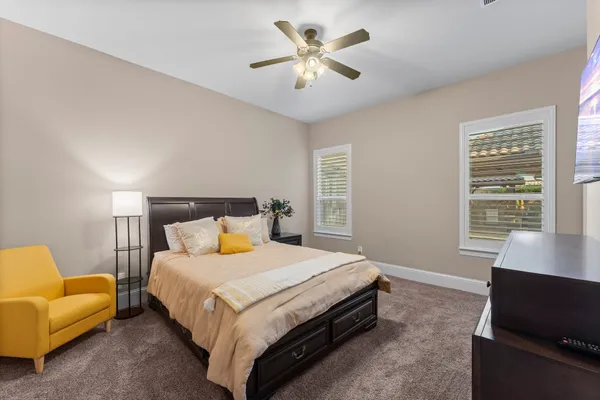 a bedroom with a bed and a couch with window