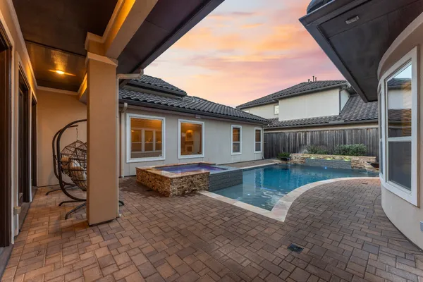 a swimming pool with outdoor seating