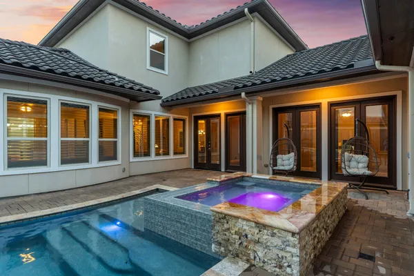a view of a house with a swimming pool and wooden floor