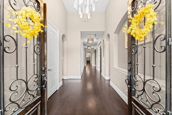 a front view of a house with a garden and plants