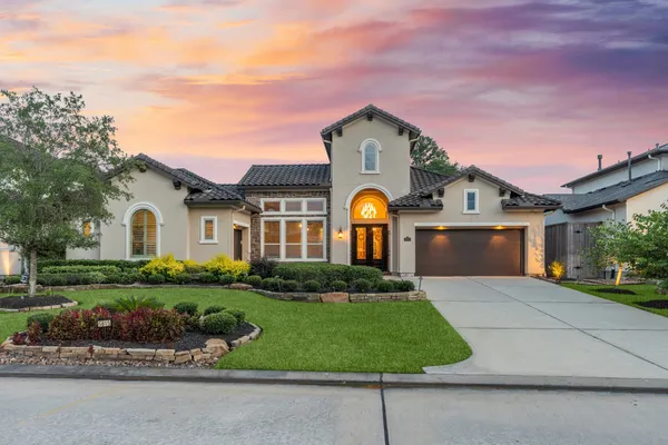 an aerial view of a house with swimming pool and outdoor seating