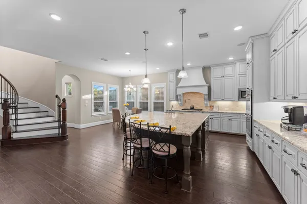 a large kitchen with a table and chairs