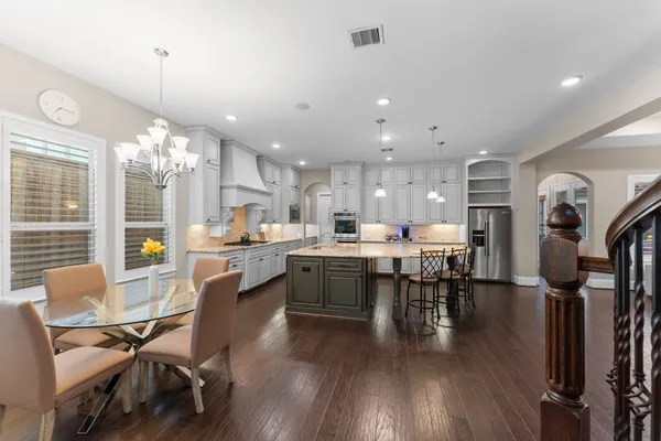 a large kitchen with a table and chairs