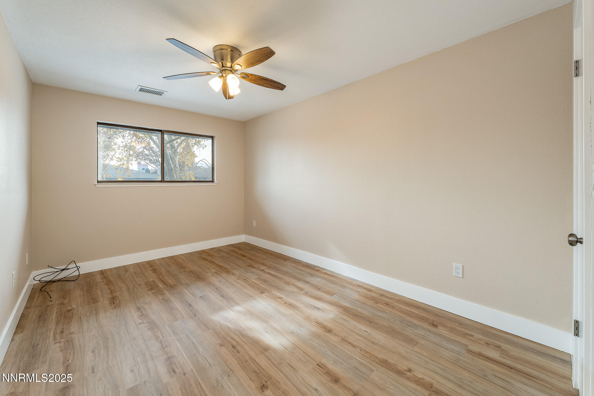 2169 Kietzke Lane, Unit B Reno, NV 89502 - Photo 13 of 20 a view of an empty room with wooden floor and a ceiling fan