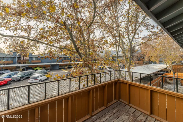 a view of a balcony with wooden floor and fence