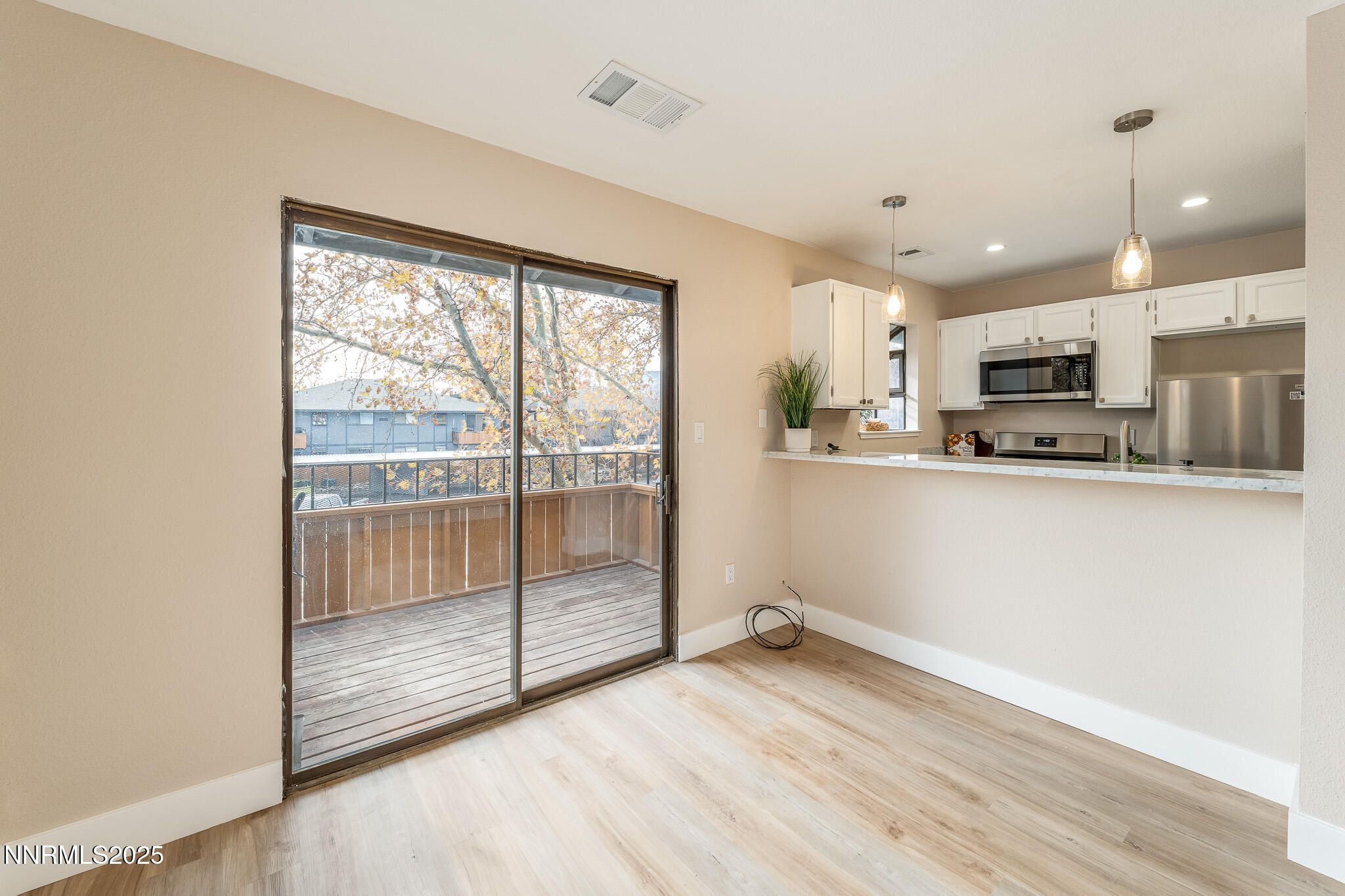 2169 Kietzke Lane, Unit B Reno, NV 89502 - Photo 3 of 20 a view of a kitchen with wooden floor and stainless steel appliances