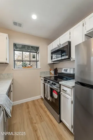 a kitchen with stainless steel appliances granite countertop a stove and a refrigerator