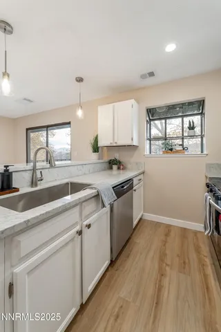 a kitchen with a sink stove and cabinets