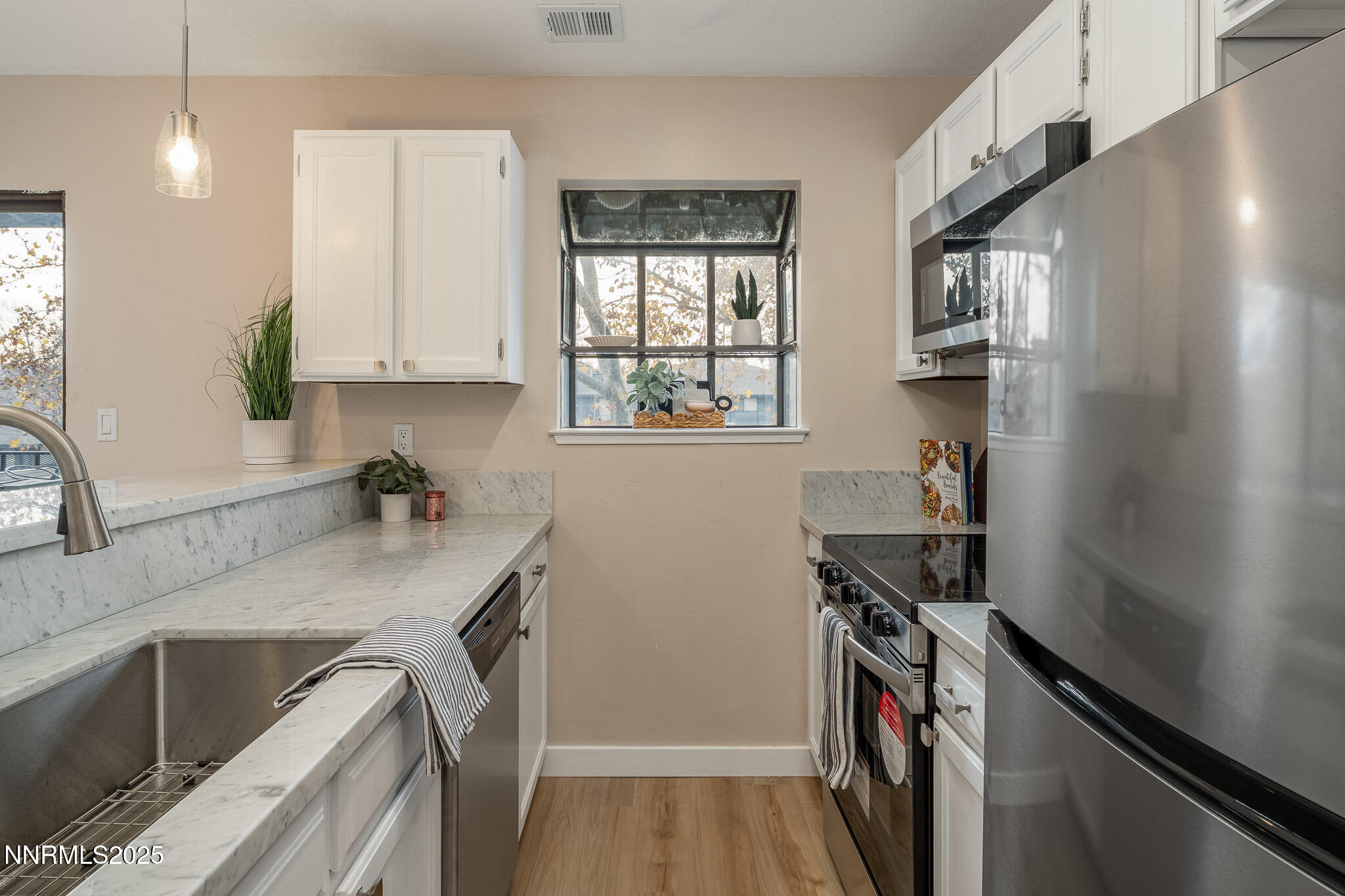 2169 Kietzke Lane, Unit B Reno, NV 89502 - Photo 8 of 20 a kitchen with stainless steel appliances granite countertop a sink stove and cabinets