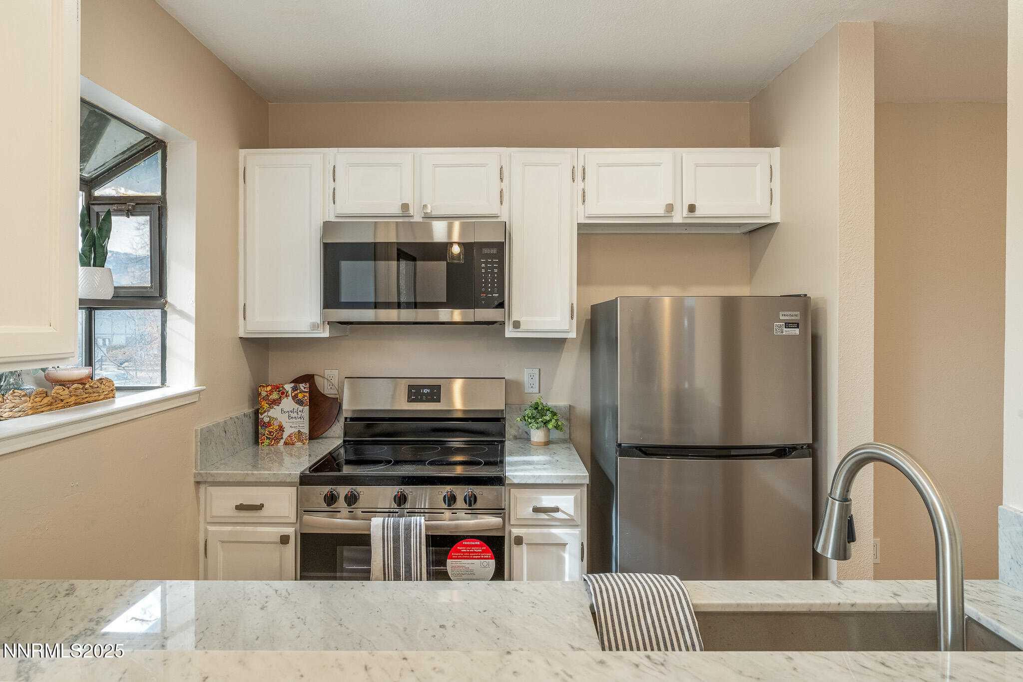 2169 Kietzke Lane, Unit B Reno, NV 89502 - Photo 9 of 20 a kitchen with stainless steel appliances granite countertop a refrigerator stove and microwave