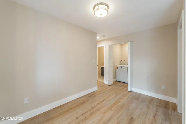 a view of a room with wooden floor and a window