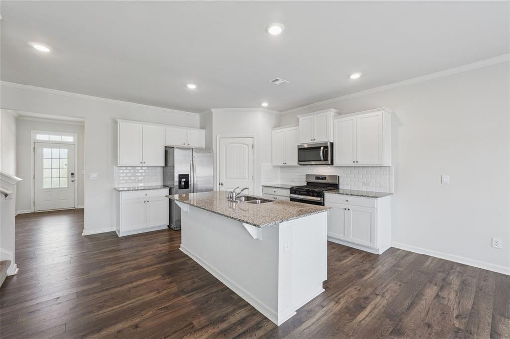 96 Quail Bend Way Dallas, GA 30157 - Photo 19 of 57 a kitchen with a sink a counter top space stainless steel appliances and cabinets