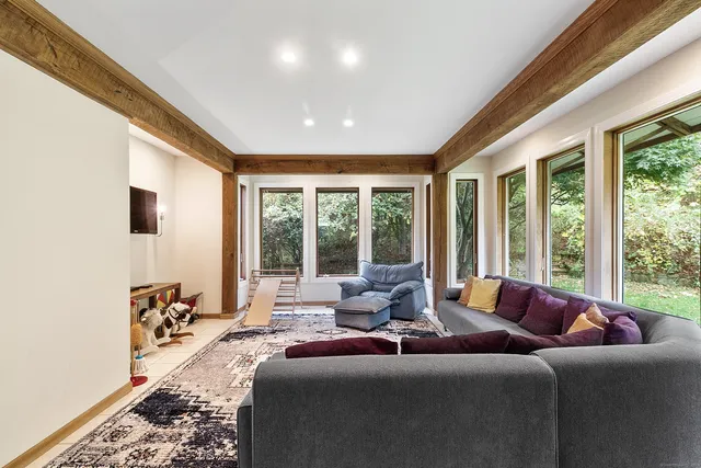 a living room with furniture and large windows