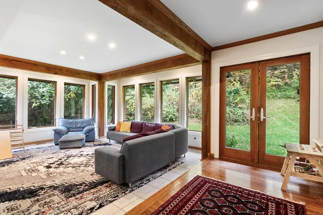 a living room with furniture and large windows