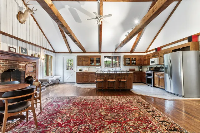 a room with lots of wooden furniture and a fireplace