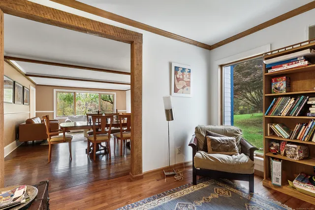 a living room with furniture and a book shelf