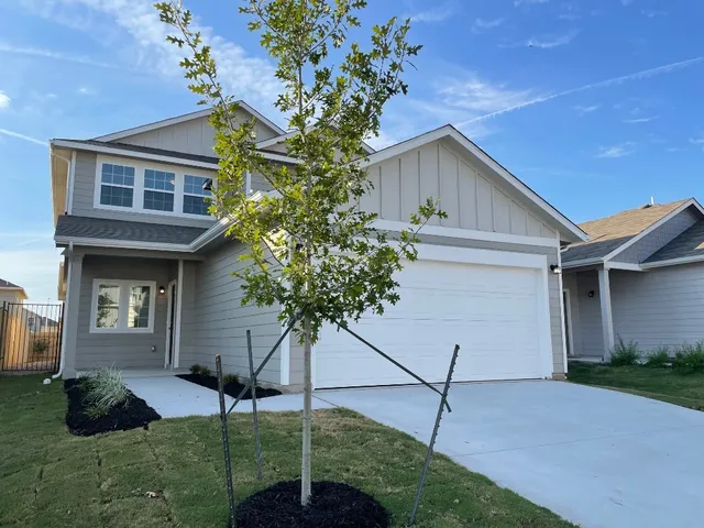a house that has a tree in front of the house