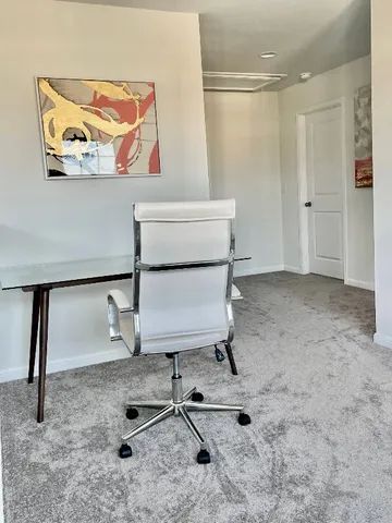 a view of a room with table and chairs