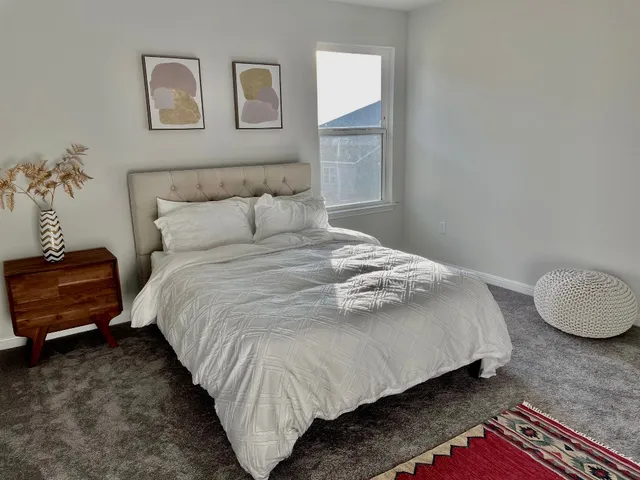 a bedroom with a bed and a chair