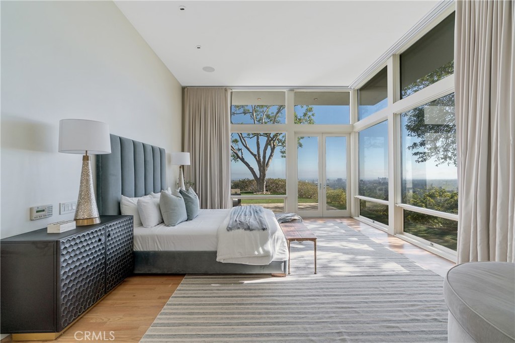 1436 Summitridge Drive Beverly Hills, CA 90210 - Photo 12 of 28 a living room with furniture large window and wooden floor