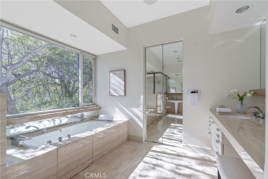 1436 Summitridge Drive Beverly Hills, CA 90210 - Photo 13 of 28 a spacious bathroom with double vanity a bathtub and a shower