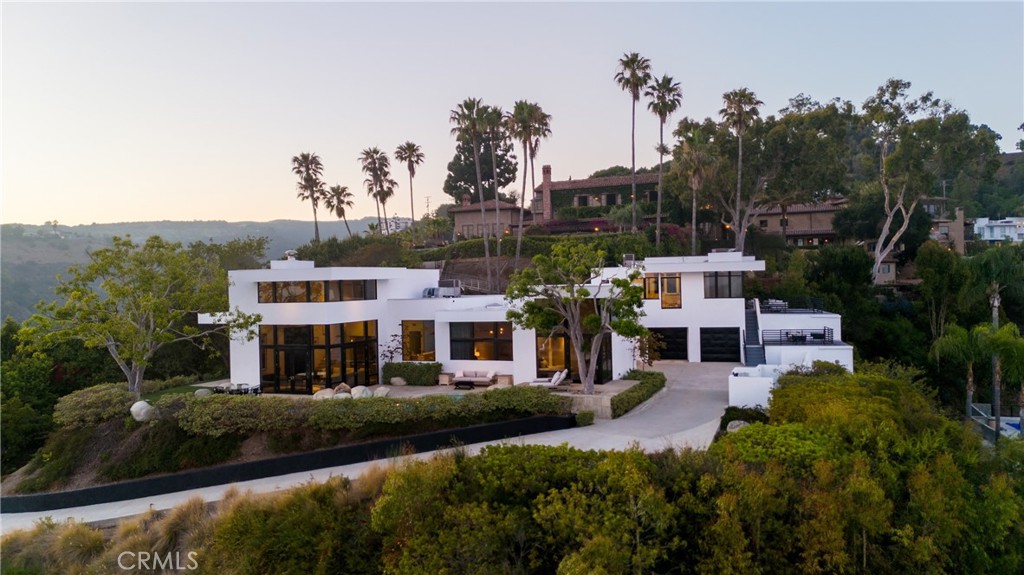 1436 Summitridge Drive Beverly Hills, CA 90210 - Photo 27 of 28 a view of house with garden and tall trees
