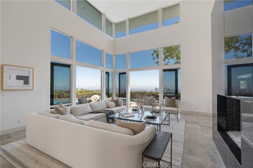 1436 Summitridge Drive Beverly Hills, CA 90210 - Photo 4 of 28 a living room with furniture and a fireplace
