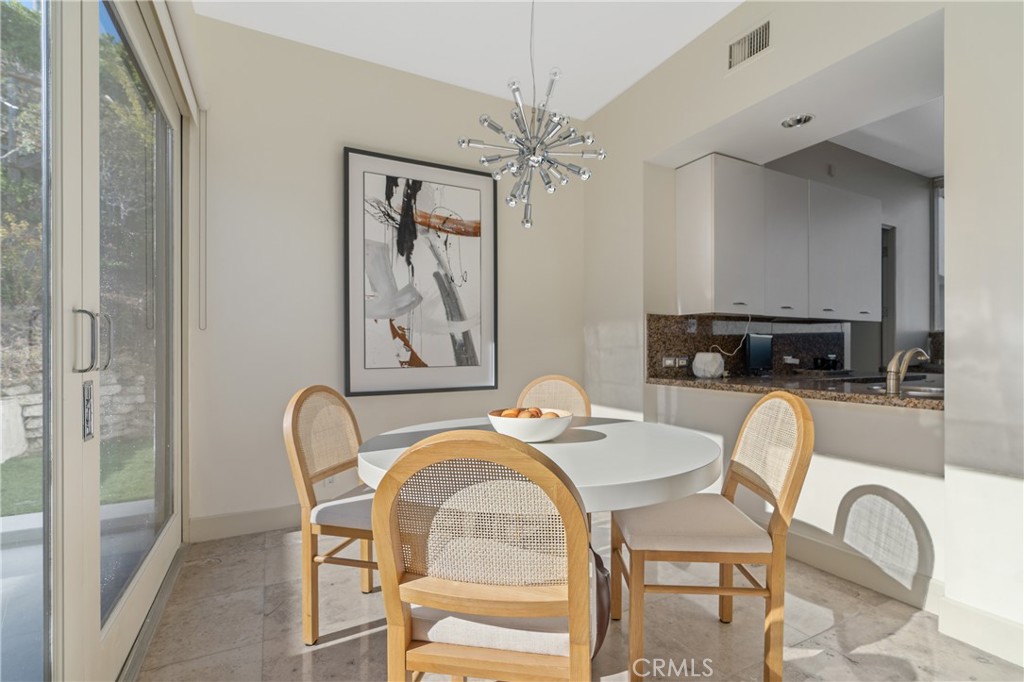 1436 Summitridge Drive Beverly Hills, CA 90210 - Photo 9 of 28 a dining room with furniture and window