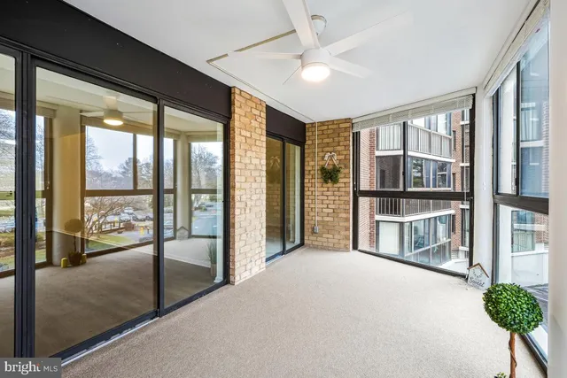 a view of an empty room with a floor to ceiling window