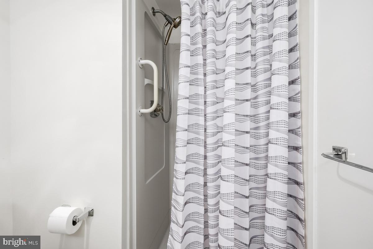 15107 Interlachen Drive, Unit 2215 Silver Spring, MD 20906 - Photo 20 of 31 a bathroom with a shower and a sink
