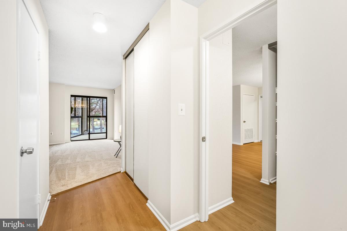 15107 Interlachen Drive, Unit 2215 Silver Spring, MD 20906 - Photo 22 of 31 a view of hallway with livingroom and wooden floor