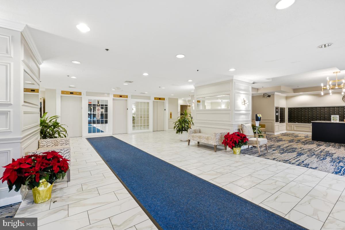 15107 Interlachen Drive, Unit 2215 Silver Spring, MD 20906 - Photo 25 of 31 a view of a lobby with a couch and potted plant