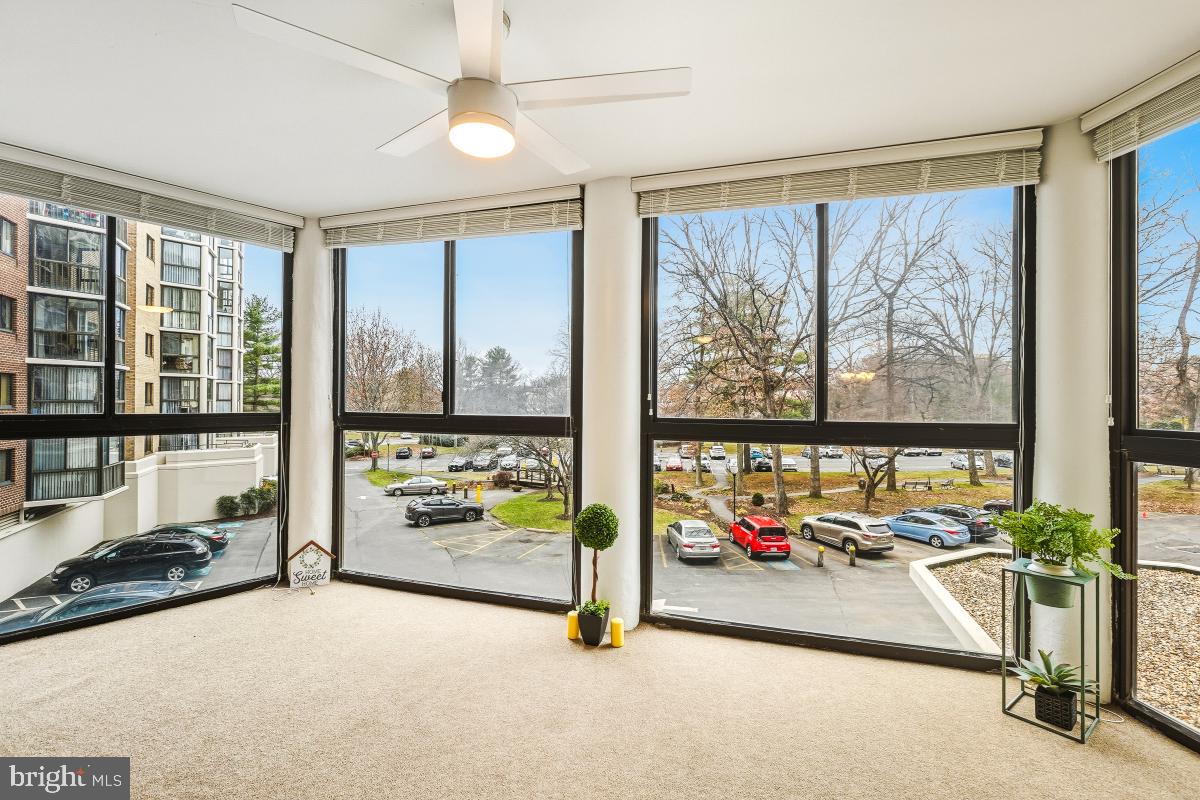 15107 Interlachen Drive, Unit 2215 Silver Spring, MD 20906 - Photo 8 of 31 a view of a room with gym equipment and floor to ceiling window