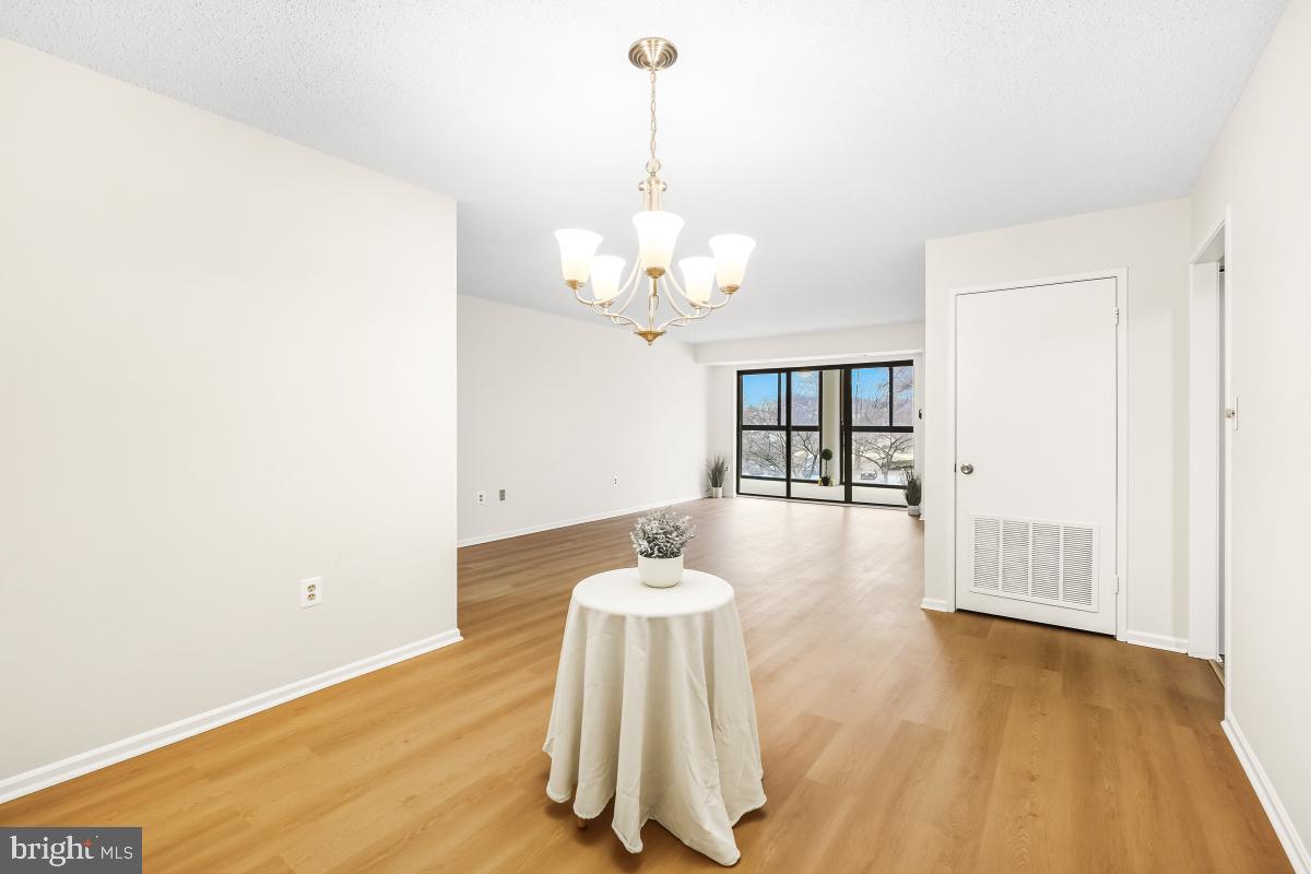 15107 Interlachen Drive, Unit 2215 Silver Spring, MD 20906 - Photo 9 of 31 a dining room with table and chairs