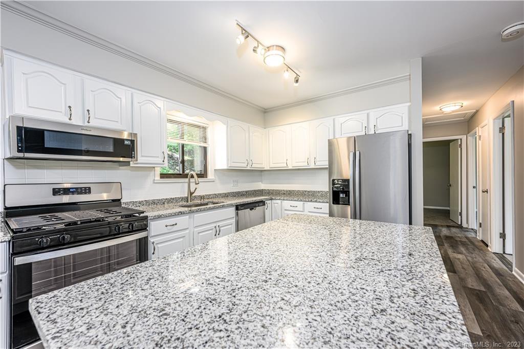 150 Platt Street Bridgeport, CT 06606 - Photo 1 of 1 a kitchen with stainless steel appliances kitchen island granite countertop a refrigerator stove and sink with granite countertops