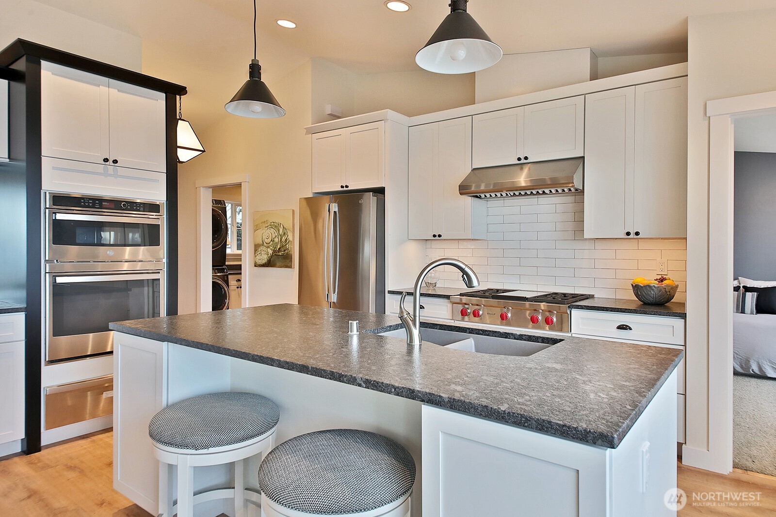 2999 Saratoga Road Langley, WA 98260 - Photo 16 of 40 a kitchen with stainless steel appliances granite countertop a sink a stove and a refrigerator