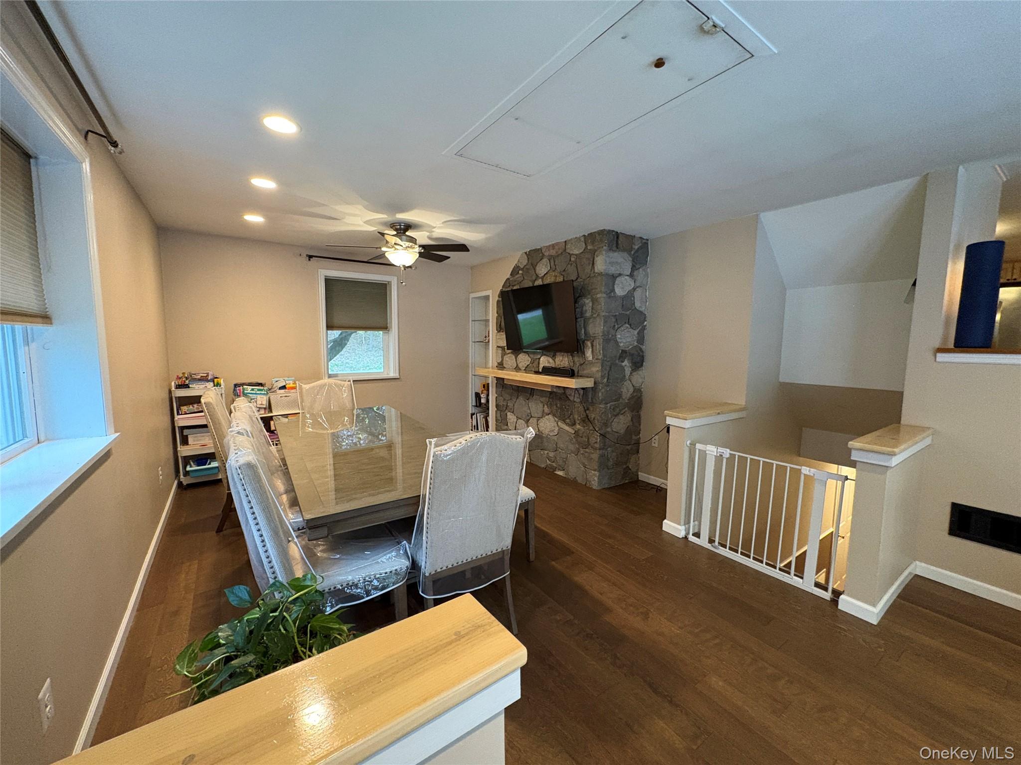 68 Whitford Road Westtown, NY 10998 - Photo 15 of 39 Spacious room featuring wood-finish flooring, recessed lighting, and a prominent stone accent wall with a wooden mantel