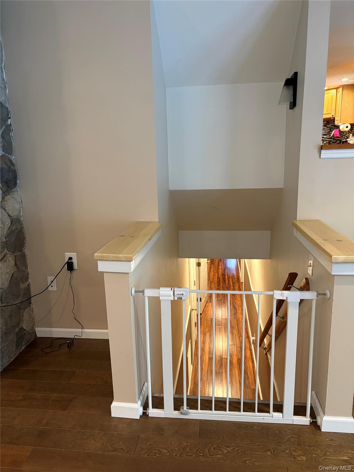 68 Whitford Road Westtown, NY 10998 - Photo 16 of 39 Hardwood flooring, light-toned wall paint, staircase with wooden handrails, stone accent wall, and recessed lighting