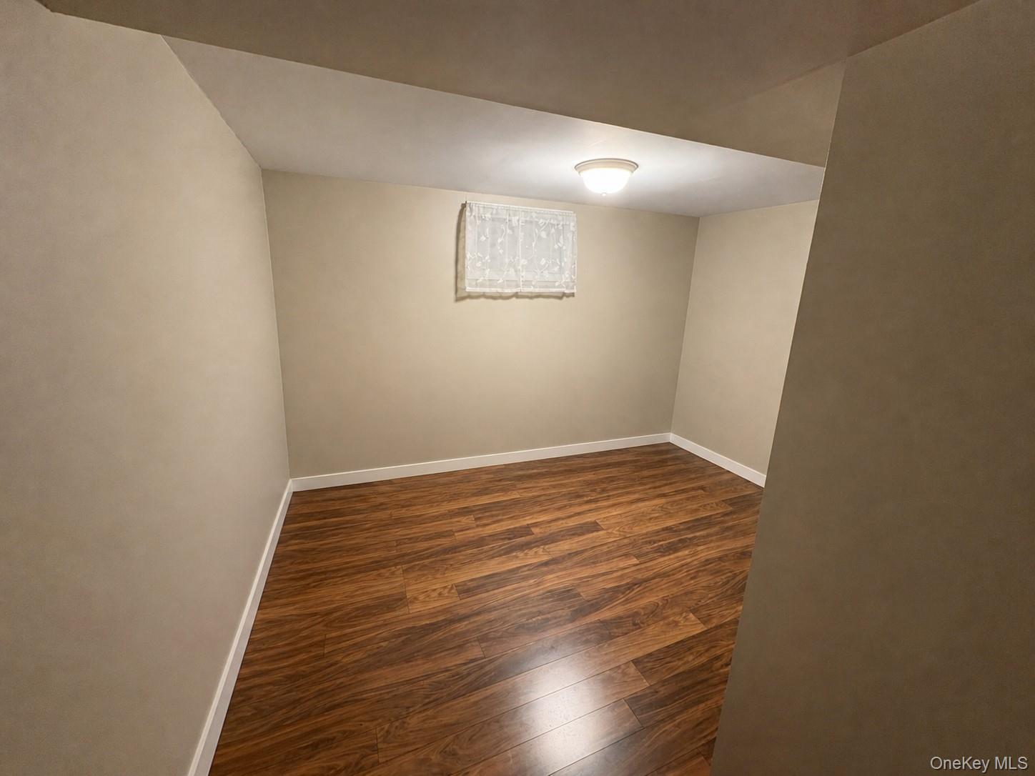 68 Whitford Road Westtown, NY 10998 - Photo 17 of 39 Compact room featuring wood-finish flooring, neutral wall paint, and white baseboards
