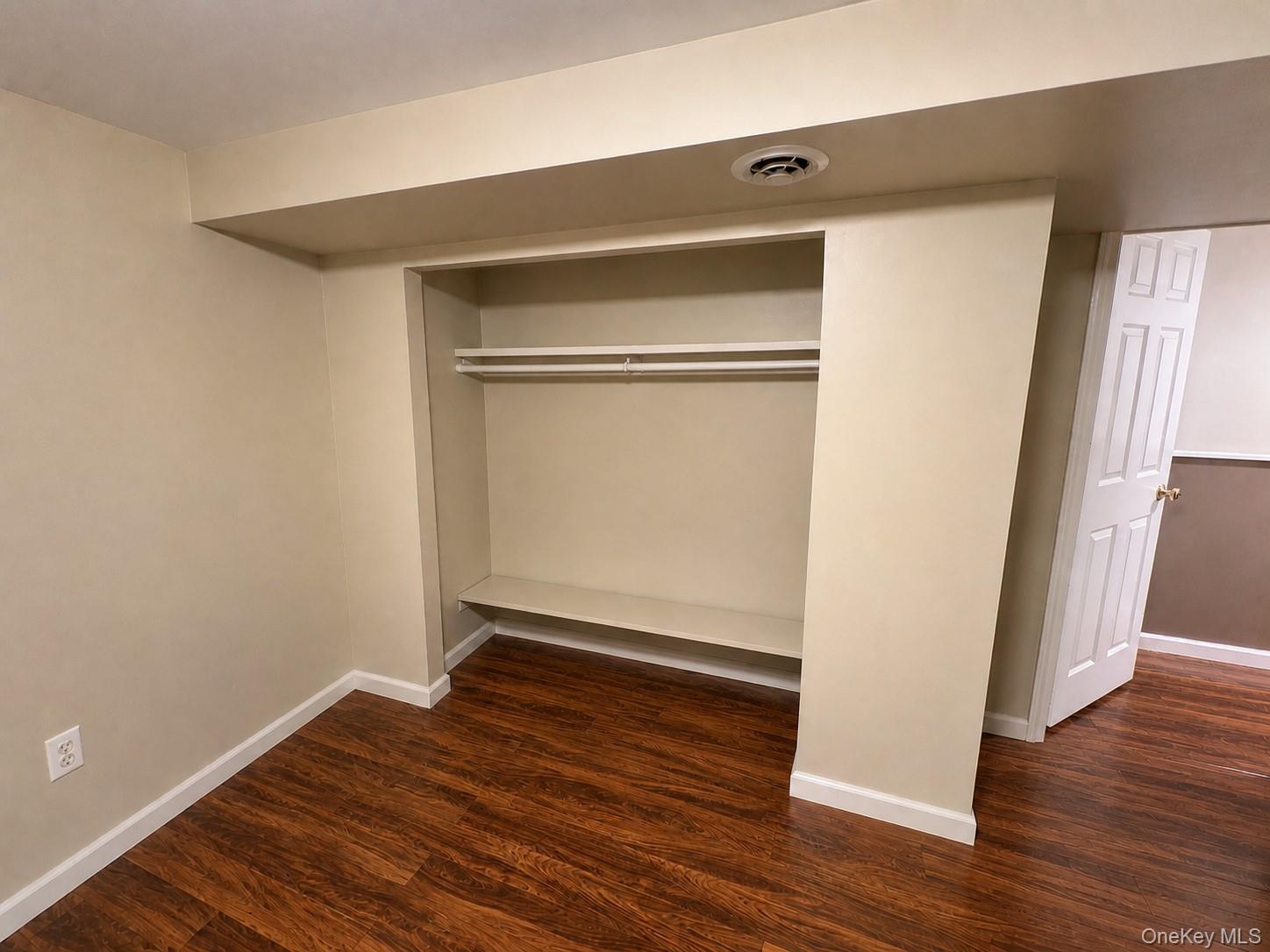 68 Whitford Road Westtown, NY 10998 - Photo 18 of 39 Built-in closet with hanging rod and integrated shelving, wood-finish flooring, and crisp white baseboards