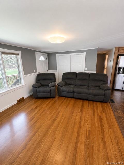 68 Whitford Road Westtown, NY 10998 - Photo 29 of 39 Spacious room featuring wood-finish flooring, a contemporary ceiling light fixture, white trim, and a window providing natural light