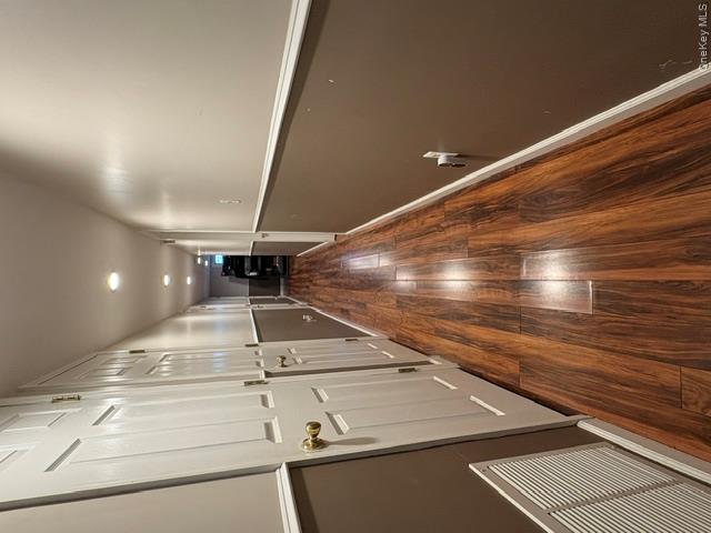68 Whitford Road Westtown, NY 10998 - Photo 31 of 39 Hallway featuring wood-finish flooring, recessed lighting, white panel doors with brass hardware, and two-tone wall treatment with chair rail molding