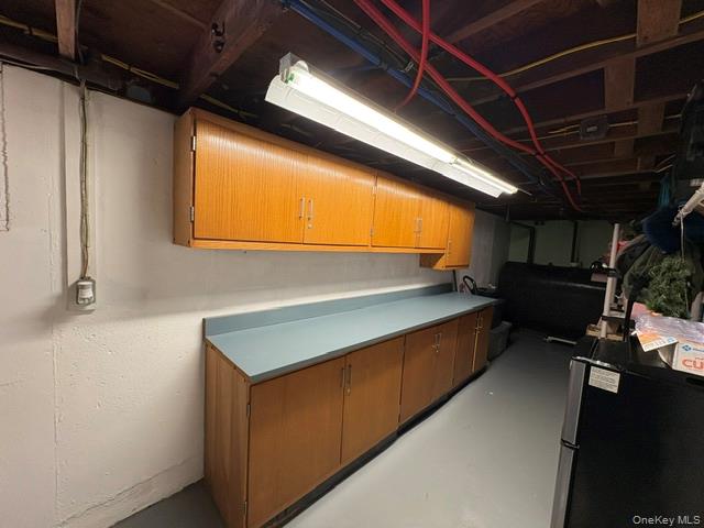 68 Whitford Road Westtown, NY 10998 - Photo 33 of 39 Utility area featuring extensive built-in cabinetry, a continuous countertop, exposed ceiling joists, and overhead strip lighting