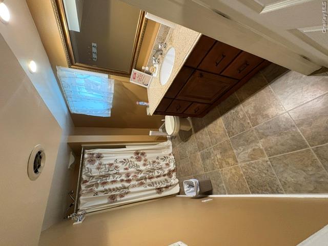 68 Whitford Road Westtown, NY 10998 - Photo 37 of 39 Bathroom featuring a vanity with a light-toned countertop, a rectangular undermount sink, and a framed mirror