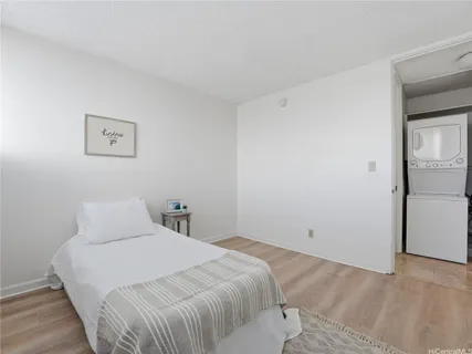 a bedroom with a bed and a painting on the wall