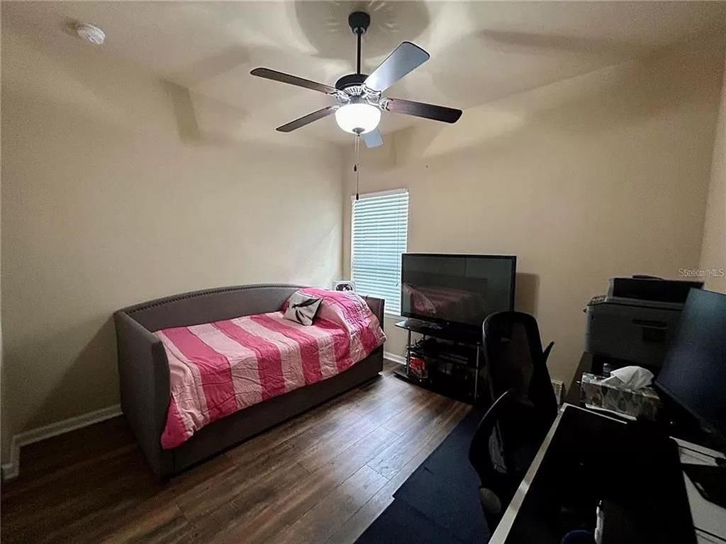 9883 Northwest 17th Road Gainesville, FL 32606 - Photo 6 of 11 a bedroom with a bed and wooden floor