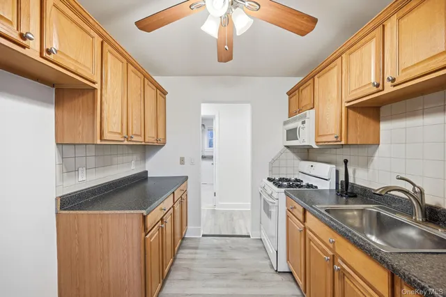 a kitchen with stainless steel appliances granite countertop a sink and cabinets